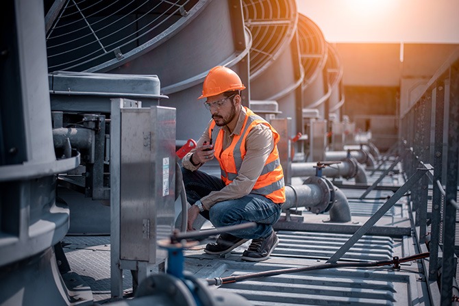 HVAC engineer inspecting existing system Who We Are
